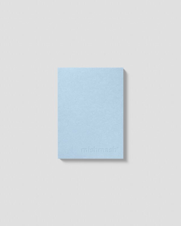 Front view of the Naked A6 notebook by Mishmash in sky blue. The Mishmash logo is embossed on the bottom right.