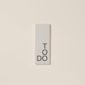 Front view of the To-Do List Pad by ThisMightWork featuring a stone-grey cover and 'TO DO' in a black sans-serif font.